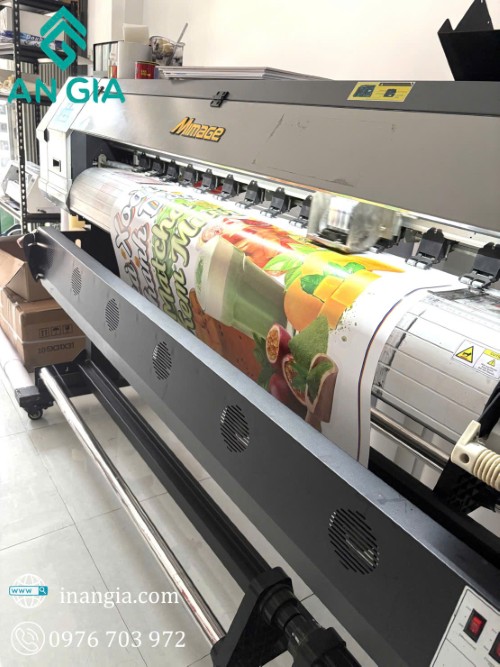 Máy in Mimaki khổ lớn đang in banner quảng cáo đồ uống màu sắc tại xưởng in ấn An Gia